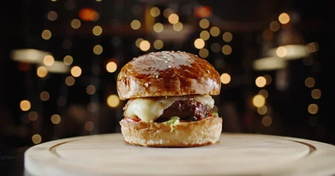 Close up shot of big appetizing burger with meat steak, lettuce, tomatoes Stock-Footage 133373890