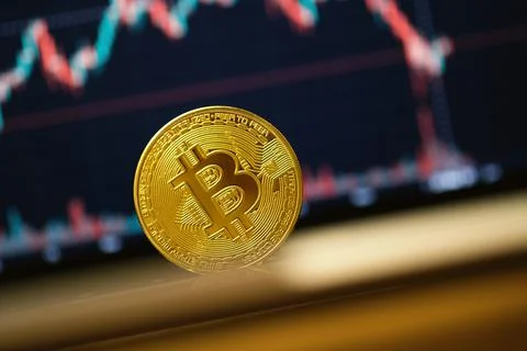 Close up shot of a Bitcoin Coin on a computers keyboard. Stock Photos