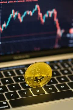 Close up shot of a Bitcoin Coin on a computers keyboard. Stock Photos
