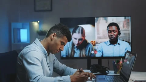 Close-up shot of Black chief manager making video call on big monitor with Video stock 143452270