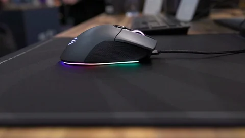 Close up shot of black computer mouse with glowing scroll wheel on a black Stock Footage 125209271