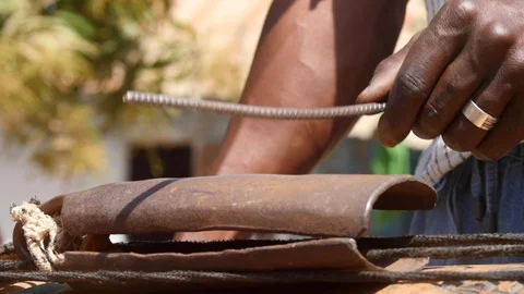 Close shot of black man hand playing kenken, metal stick on bell Video stock 113166782