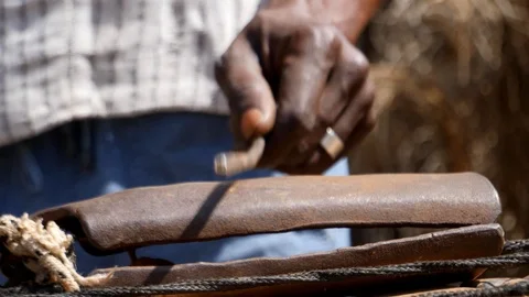 Close shot of black man hand playing kenken, metal stick on bell Stock-Footage 113166808