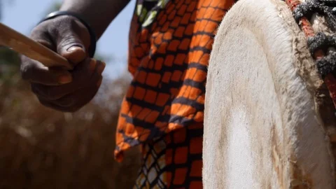 Close shot of black man hand hitting skin of Dunun with wooden stick Video stock 113167585