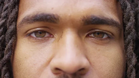 Close up shot of black man opening his eyes and staring to camera  Stock-Footage 142816664