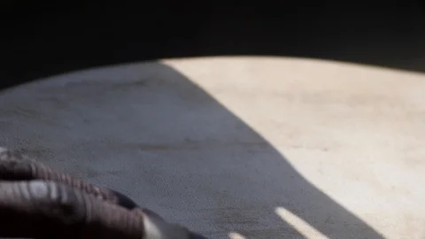 Close shot of black man playing djembe with plaster on finger Stock Footage 113165819