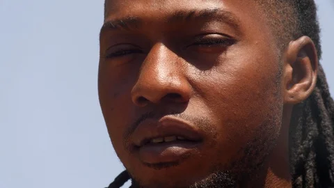 Close shot of black man playing dundun and shaking head with the music Stock Footage 113166844