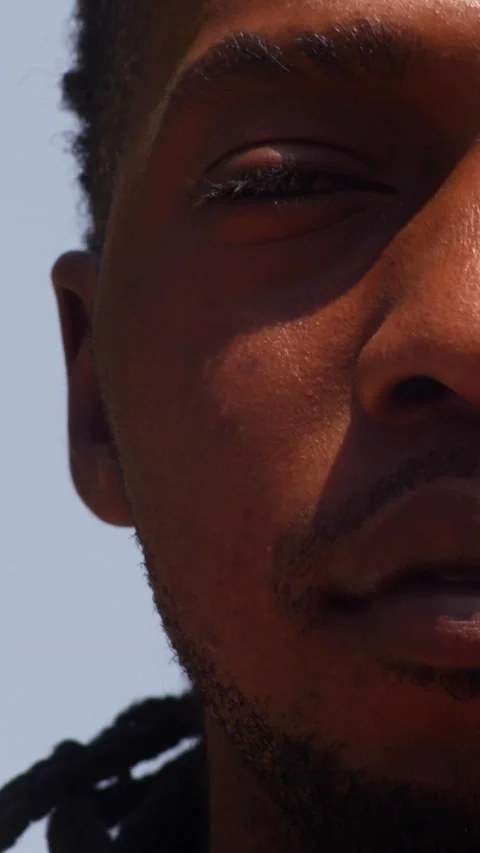 Close shot of black man playing dundun and shaking head with the music Stock Footage 230664005