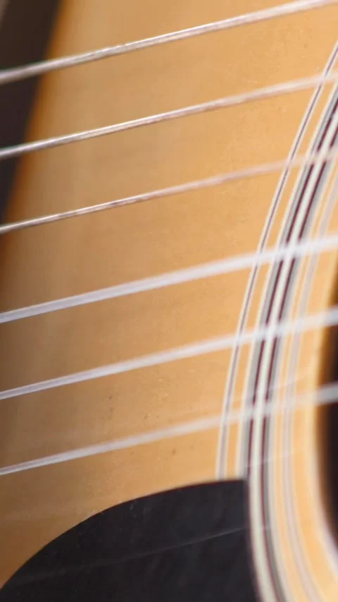 Close shot of black man playing acoustic guitar sitting on chair Stock Footage 230664847