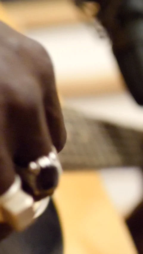 Close shot of black man playing acoustic guitar sitting on chair Stock Footage 230664936