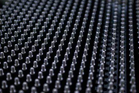 Close up shot of black screw thread bolts rowed up to a pattern background Ar Stock Photos