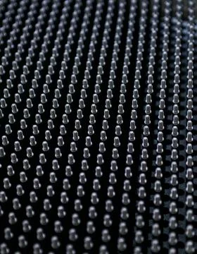 Close up shot of black screw thread bolts rowed up to a pattern background Ar Foto stock
