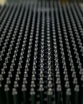 Close up shot of black screw thread bolts rowed up to a pattern background Ar Foto stock