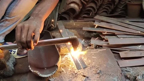 Close up shot of blacksmith cut metal with the flame of a blowtorch in workshop. Stock Footage 196325068