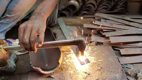 Close up shot of blacksmith cut metal with a flame in workshop. Stock Footage 196326012