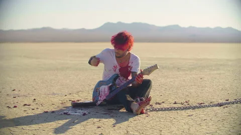 Close up shot of a bleeding young man, playing a broken guitar Video stock 293113107