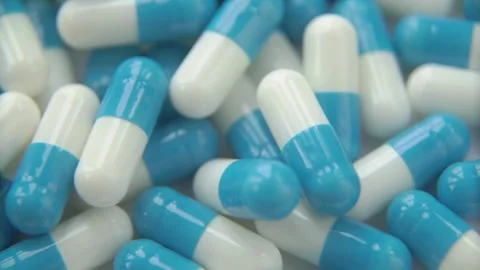 Close up shot of blue and white medical capsules Stock Footage 333875368
