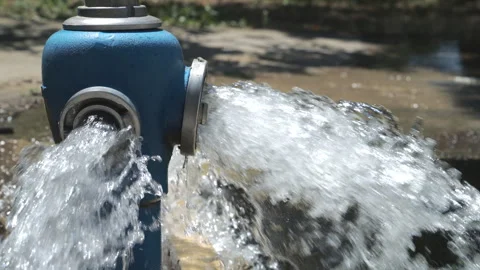 Close-up shot of a blue fire hydrant flushing out high-pressure water from .. Stock Footage 339652452