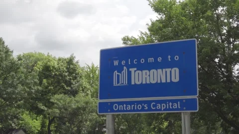 Close up shot of a blue, welcome to Toronto sign Stock Footage 252153528