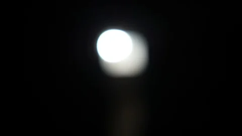 Close up shot of a blurred light spot of street-lamp at dark night time Stock Footage 119988434