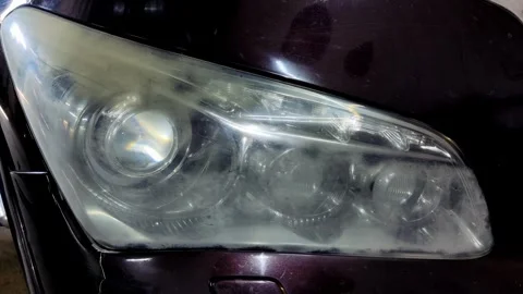 A close-up shot of a blurry and hazy car headlight Stock Footage 336274143