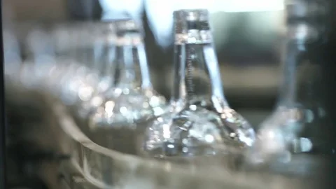 Close-up shot of bottles in a row on a conveyor belt Stock Footage 71701010