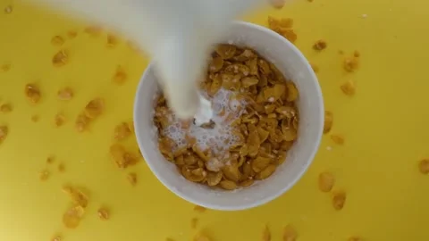 Close-up shot, Breakfast Cereal in a white bowl, Milk pouring into a bowl of Stock Footage 131606944