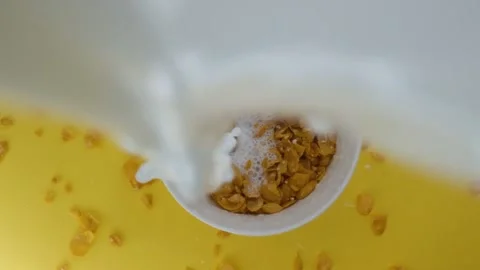 Close-up shot, Breakfast Cereal in a white bowl, Milk pouring into a bowl of Stock Footage 131607101