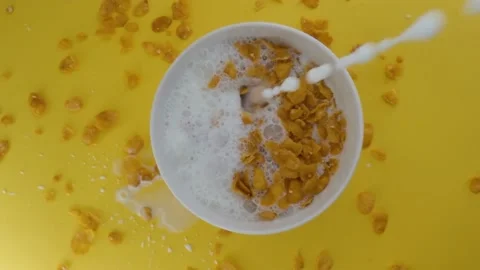 Close-up shot, Breakfast Cereal in a white bowl, Milk pouring into a bowl of Stock Footage 131607319