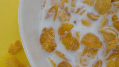 Close-up shot, Breakfast Cereal in a white bowl, Milk pouring into a bowl of Stock Footage 131607589