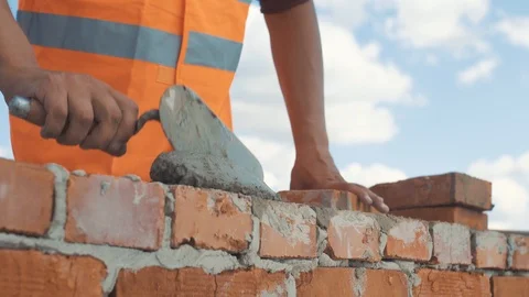 Close-up shot of Bricklayer put brick on the wall Stock Footage 92071640