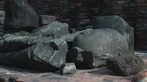 Close up shot of  broken buddha statue laid on the floor in Ayutthaya, thailand. Video stock 306773784