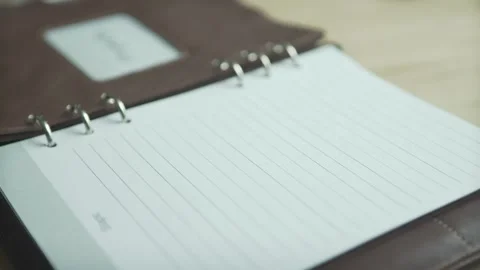 Close up shot of brown leather note pad book business project daily planner bull Stock Footage 137538868