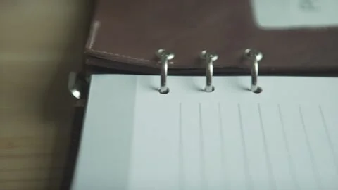 Close up shot of brown leather note pad book empty white paper pages daily plann Stock Footage 137538895