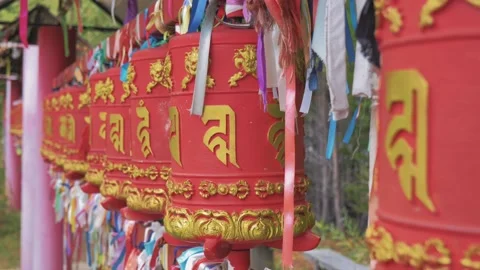 Close-up shot of buddhist prayer wheels inscribed with a mantras and surrounded Stock Footage 220107564