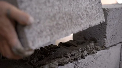 Close up shot of a builder working on a site and bulding a wall. Stock Footage 87618883