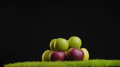 Close up shot of a bunch of green and red apples on a black background Stock Footage 113056112