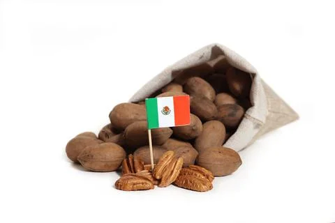 Close-up shot of a burlap bag of pecans with a flag of Mexico on a white backgro Stock Photos