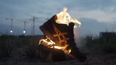 Close up shot of burning boots strong bright flame summer dark night Slow motion Stock Footage 95909686