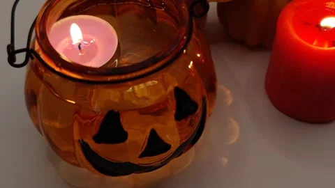 Close-up shot of burning candle flame. Halloween holiday decor. Stock Footage 319789737