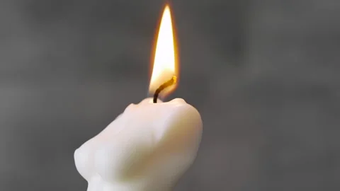 Close-up shot of a burning candle in the shape of a woman's body. Stock Footage 267014444