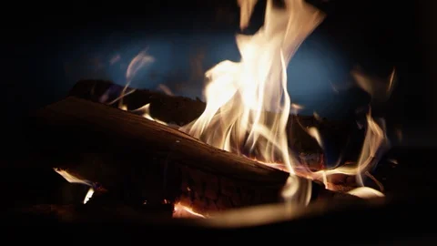 Close up shot of burning logs on a campfire with abstract car headlights Stock Footage 121764703