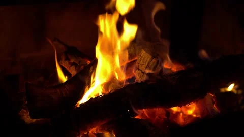 Close shot of burning logs in crackling fire in dark Stock Footage 135526225