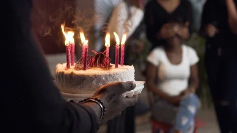 Close up shot of cake with burning candles on the african birthday girl on the Stock Footage 102550106