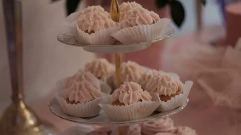 Close-up shot of cakes with cream capcake on festive table Stock Footage 76475355