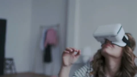 Close-up shot. Camera moves around young girl wearing mobile virtual reality Stock Footage 106489909