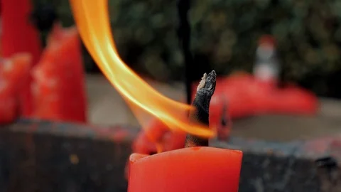Close-up shot of a candle burning in a Buddhist temple., China. Stock-Footage 118070848