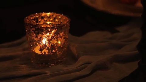 Close up shot of candle in candlestick on the table with cloth. Video stock 76970741