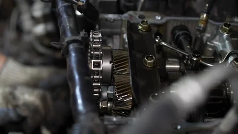 A close-up shot captures the internal gears and a timing chain assembly insid Stock Footage 345108183