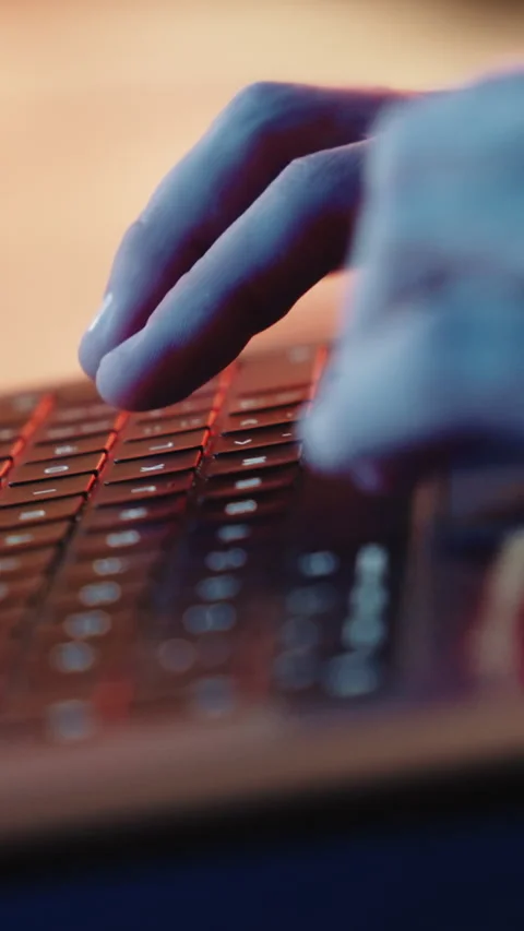 A close-up shot captures a mans hands actively typing on a laptop. The Stock Footage 321331829